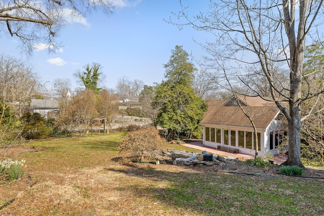 view of yard featuring a sunroom