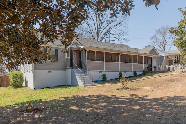 single story home featuring a shingled roof, fence, a front yard, and a sunroom