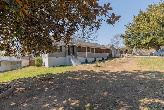 exterior space with fence, a yard, roof with shingles, a sunroom, and crawl space