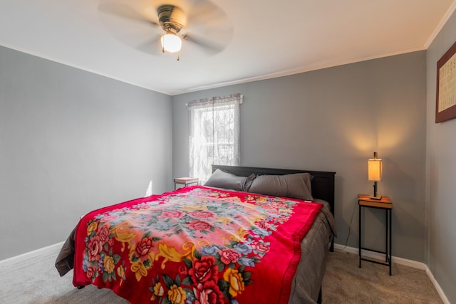 carpeted bedroom featuring crown molding, baseboards, and ceiling fan