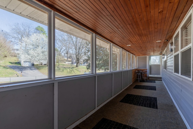 unfurnished sunroom featuring wooden ceiling