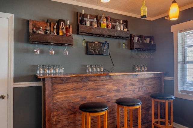 bar featuring a dry bar and crown molding