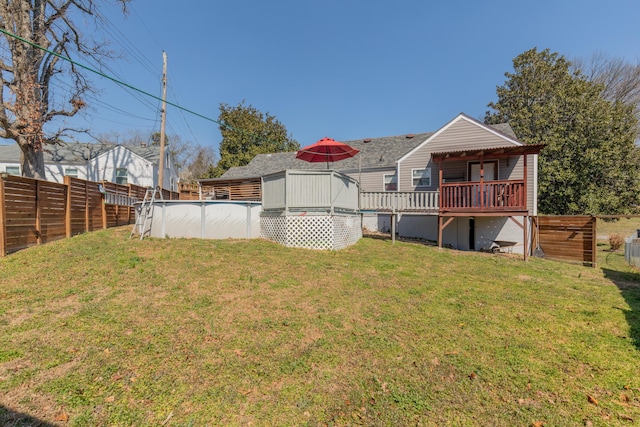 view of yard with a fenced in pool, a fenced backyard, and a wooden deck