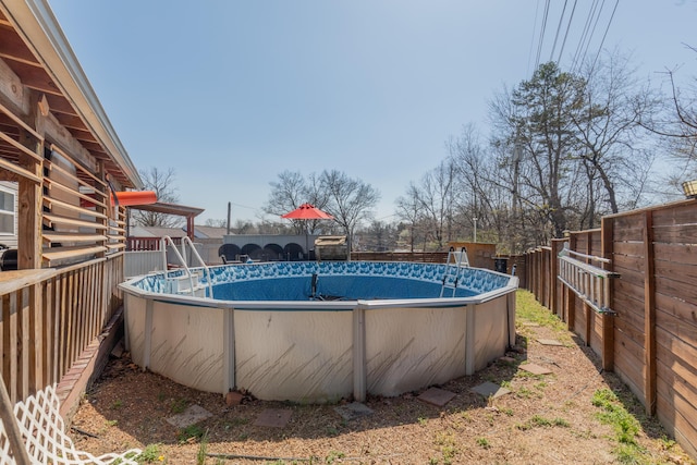 view of swimming pool with a fenced in pool and a fenced backyard