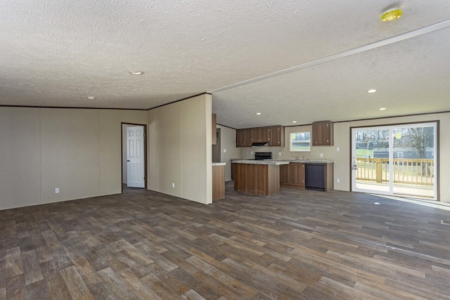 unfurnished living room featuring dark wood finished floors, recessed lighting, and a textured ceiling