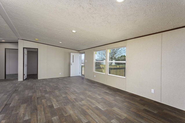 interior space with recessed lighting, a textured ceiling, wood finished floors, and ornamental molding