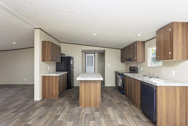 kitchen with black appliances, a sink, dark wood-style floors, a center island, and light countertops