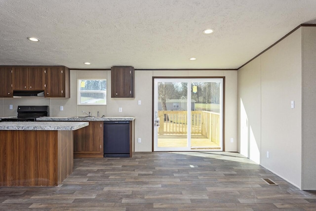 kitchen with range hood, dark wood finished floors, light countertops, black electric range, and dishwasher