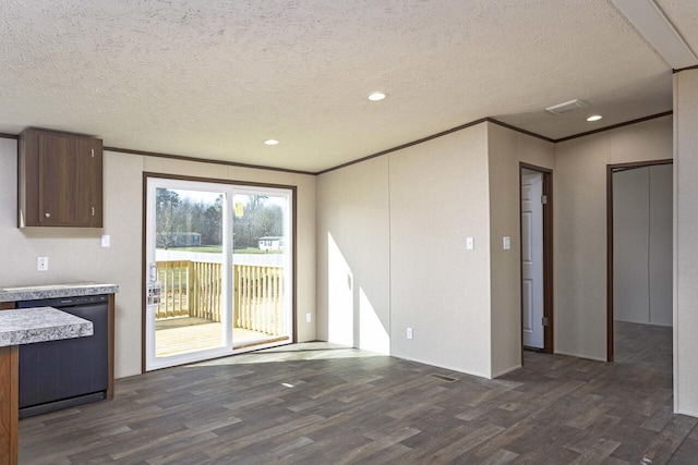 unfurnished living room featuring a textured ceiling, recessed lighting, dark wood-style floors, and ornamental molding