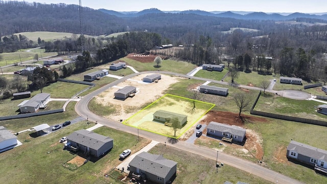 birds eye view of property with a mountain view and a view of trees