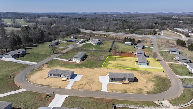 drone / aerial view with a view of trees and a rural view