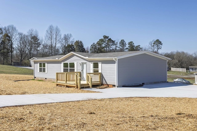 back of house featuring crawl space and a wooden deck