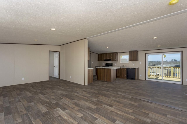 unfurnished living room with recessed lighting, a textured ceiling, and dark wood-style flooring