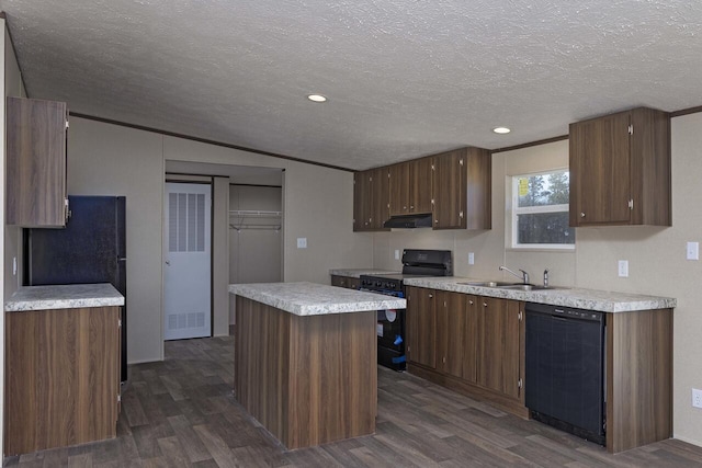 kitchen with dark wood-style flooring, black appliances, light countertops, and a sink