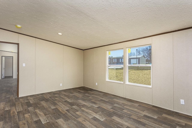 empty room with dark wood-type flooring, crown molding, and a textured ceiling