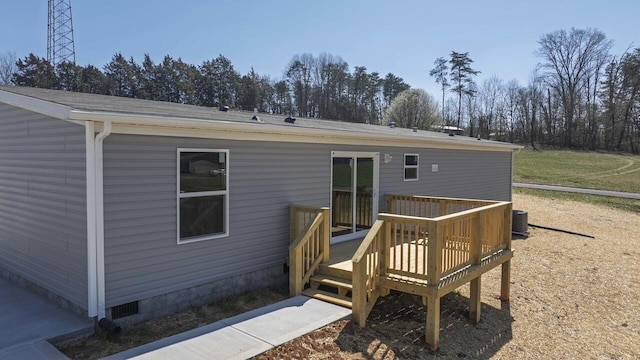 rear view of property with a deck, central AC, and crawl space