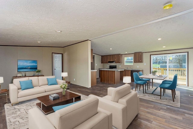 living room with recessed lighting, a textured ceiling, and wood finished floors