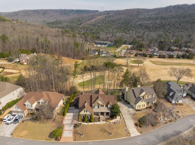 drone / aerial view featuring a residential view and a forest view