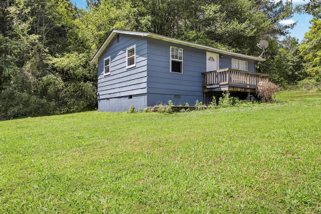 view of front of property with a deck, a front yard, and crawl space