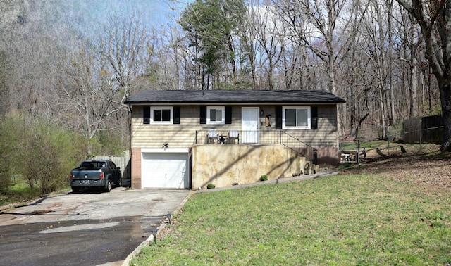 single story home featuring an attached garage, driveway, and a front lawn