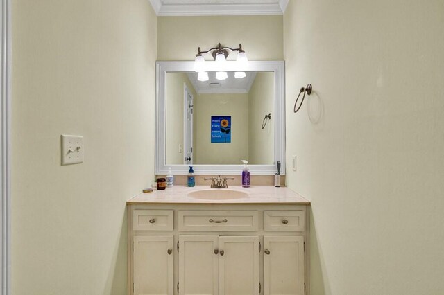 bathroom with vanity and ornamental molding