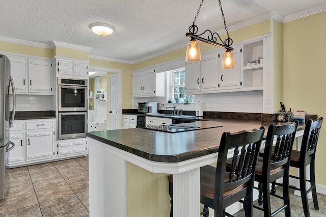 kitchen featuring dark countertops, appliances with stainless steel finishes, a peninsula, and open shelves