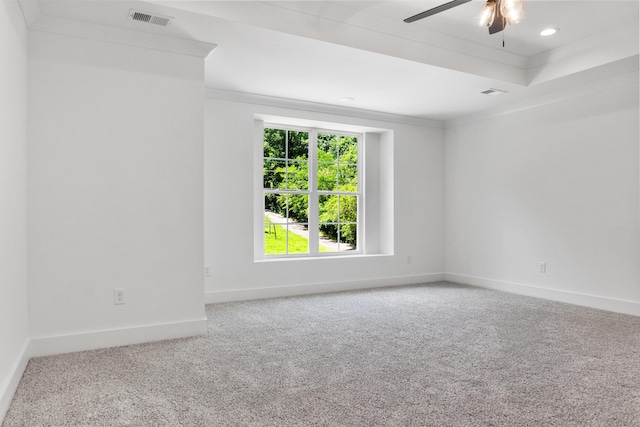 empty room with baseboards, carpet, visible vents, and ornamental molding