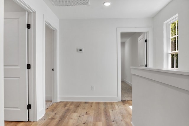 corridor with visible vents, recessed lighting, light wood-type flooring, and baseboards