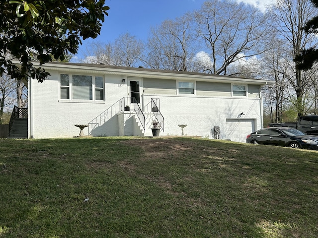 ranch-style house with a front yard, brick siding, and an attached garage