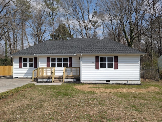 ranch-style house featuring a shingled roof, a front lawn, fence, and crawl space