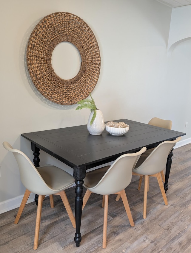 dining room with baseboards and wood finished floors