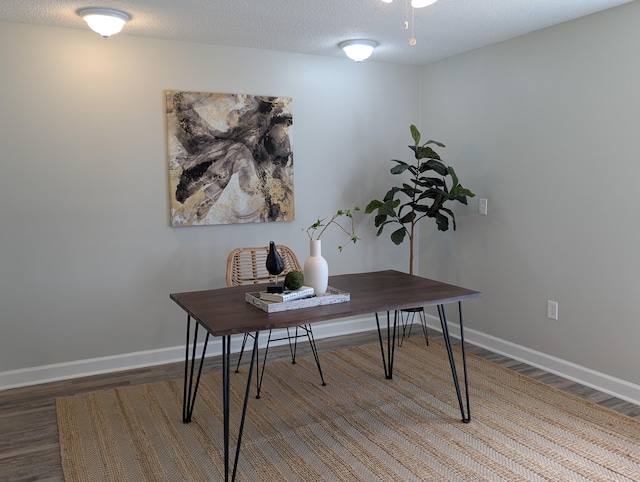 office area with wood finished floors, baseboards, and a textured ceiling