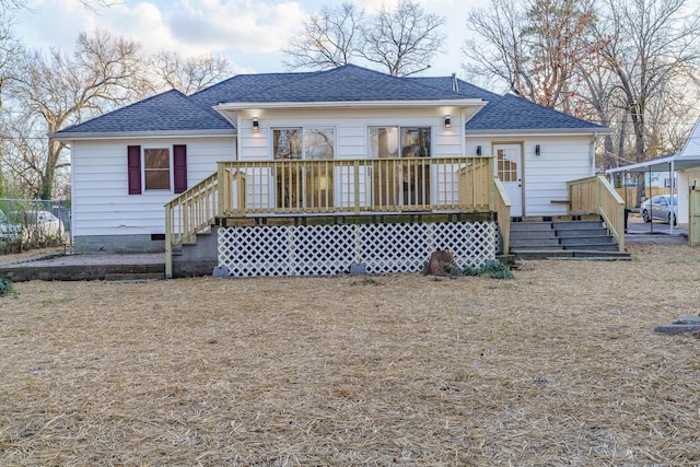 back of house with crawl space, a wooden deck, and a shingled roof