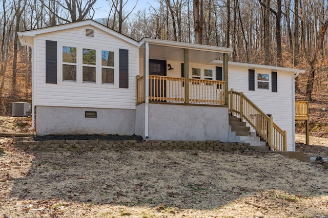 view of front of property with crawl space, central air condition unit, and a porch