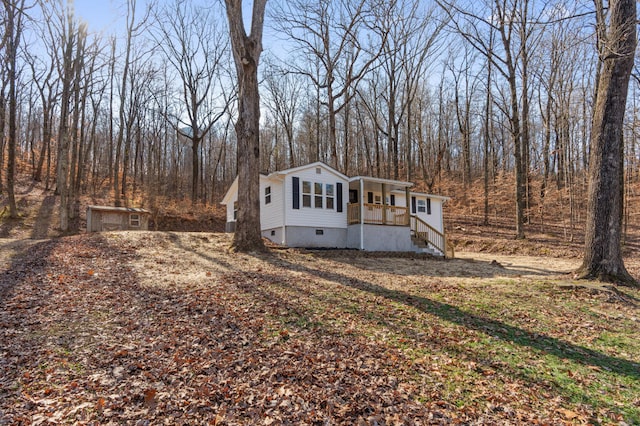 manufactured / mobile home with a forest view and crawl space