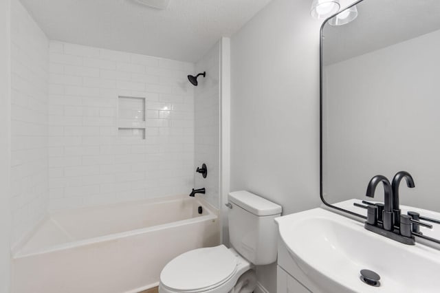 bathroom featuring vanity, toilet, washtub / shower combination, and a textured ceiling