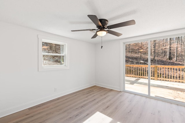 unfurnished room featuring ceiling fan, baseboards, and wood finished floors