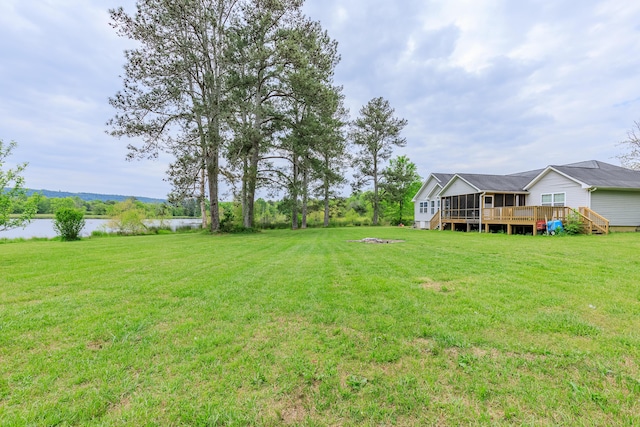 view of yard featuring a deck with water view