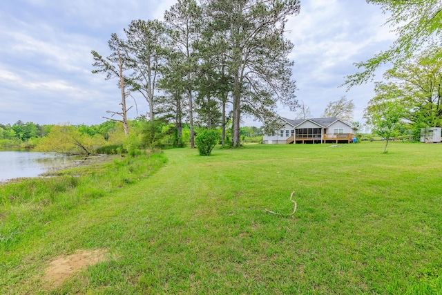 view of yard with a deck with water view