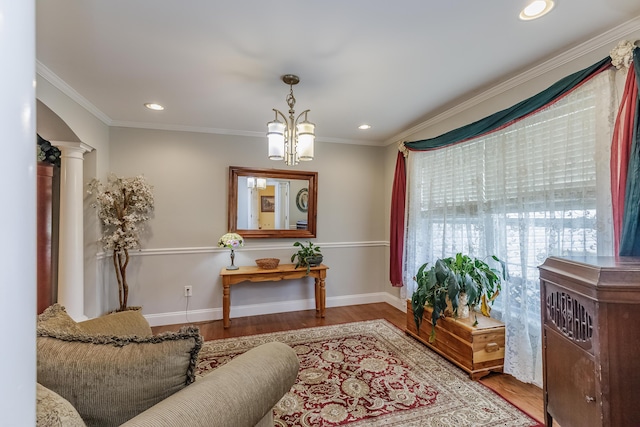 sitting room featuring a notable chandelier, wood finished floors, recessed lighting, crown molding, and baseboards