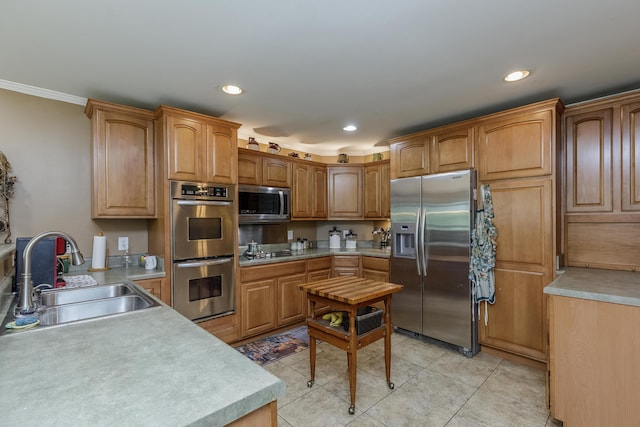 kitchen featuring light tile patterned floors, recessed lighting, appliances with stainless steel finishes, and a sink