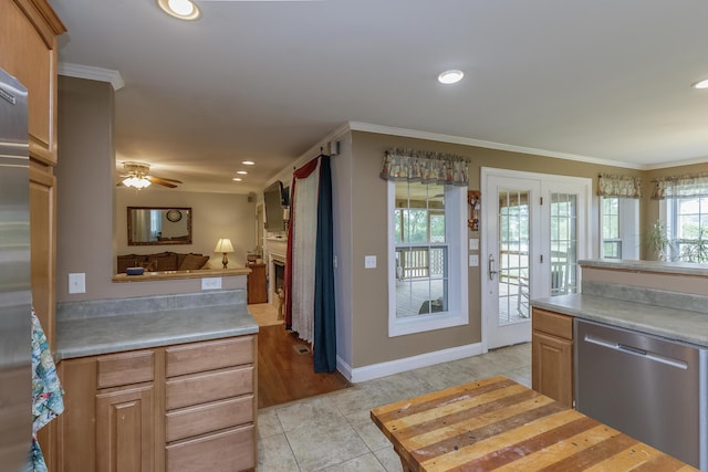 kitchen featuring light tile patterned floors, ornamental molding, light countertops, and stainless steel dishwasher