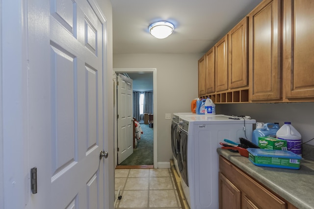 washroom with cabinet space, light tile patterned floors, and separate washer and dryer