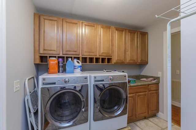 clothes washing area with visible vents, cabinet space, independent washer and dryer, and light tile patterned flooring