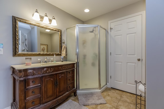 bathroom featuring tile patterned floors, a stall shower, and vanity