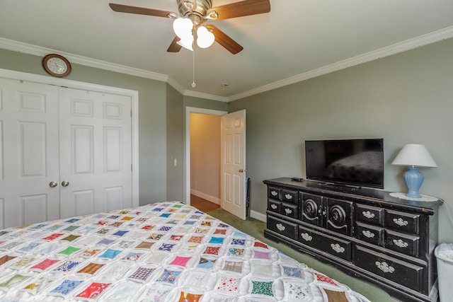 carpeted bedroom with a closet, baseboards, ceiling fan, and crown molding