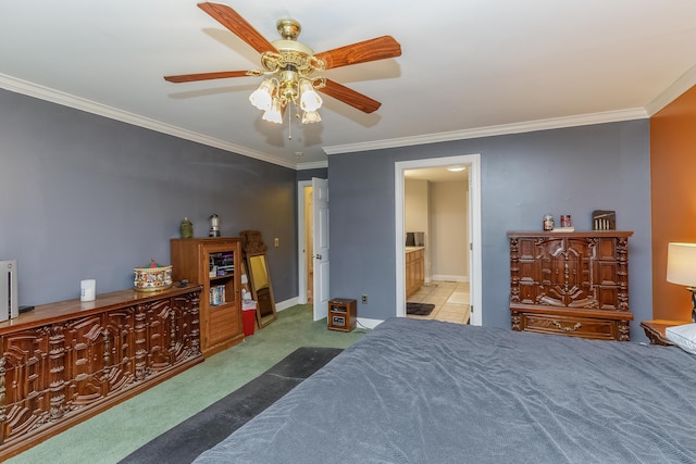 bedroom with crown molding, ensuite bathroom, a ceiling fan, and carpet floors