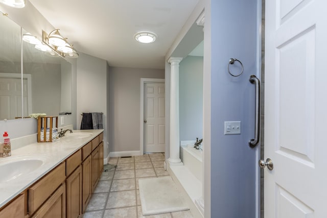 full bathroom featuring a garden tub, double vanity, baseboards, and a sink