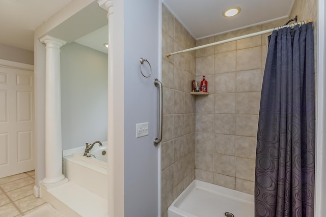 full bathroom featuring tile patterned flooring, a garden tub, decorative columns, and a stall shower