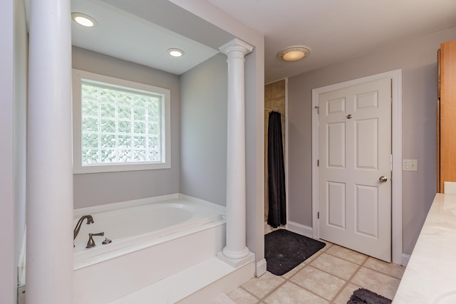 full bathroom with a shower with shower curtain, baseboards, ornate columns, tile patterned flooring, and a bath